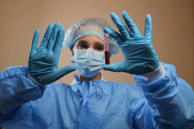 A nurse holds a test tube with a coronavirus positive blood sample 2019 nCoV pandemic MERS