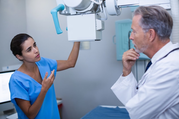 Nurse interacting with doctor in x-ray room