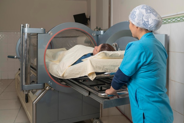 Nurse introducing a patient to enter the hyperbaric tank