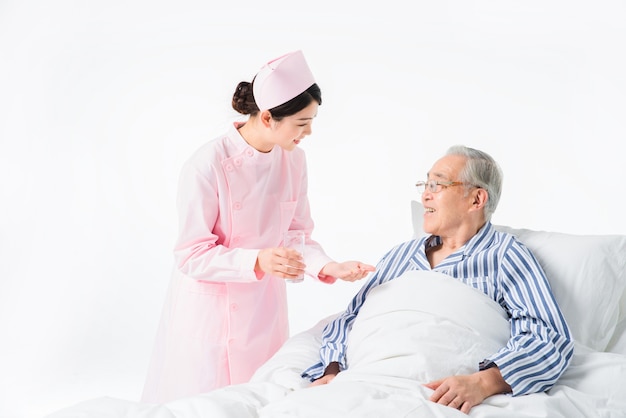 Nurse and old man taking medicine