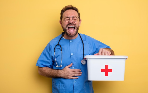 Nurse or physician laughing out loud at some hilarious joke. business and phone concept .first aid kit concept