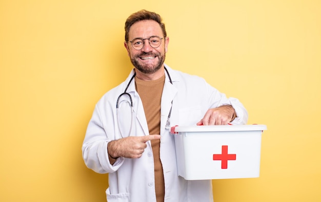 Nurse or physician looking excited and surprised pointing to the side business and phone concept first aid kit concept