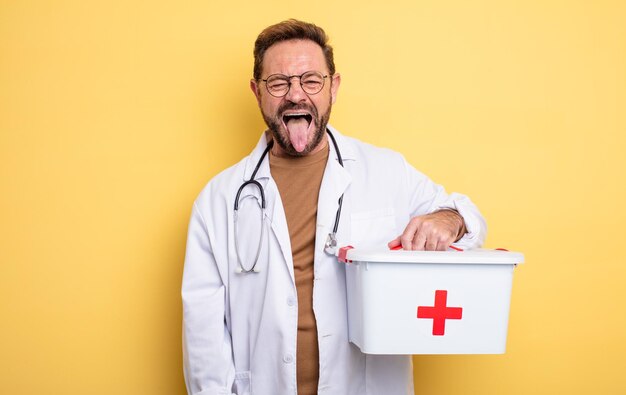 Nurse or physician with cheerful and rebellious attitude joking and sticking tongue out business and phone concept first aid kit concept