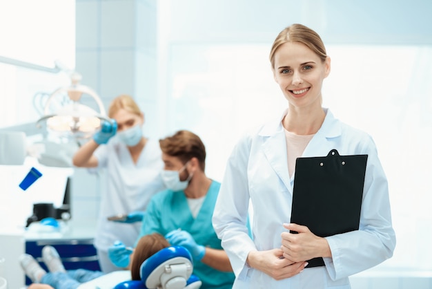 A nurse posing with dentists