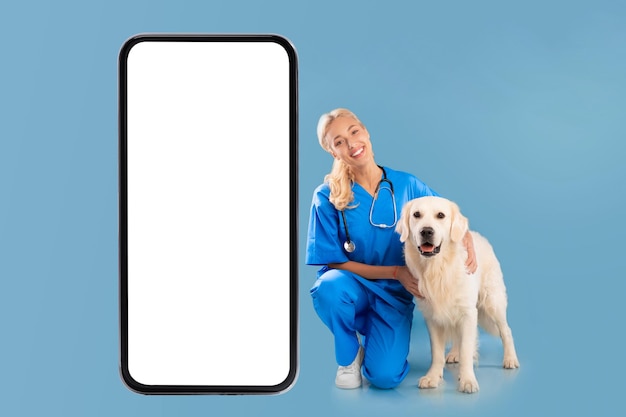 Nurse posing with dog near giant white cell screen