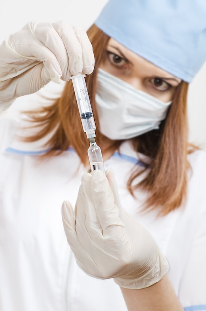 Photo nurse prepares a vaccine for injection