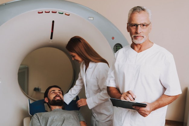 Nurse Preparing Patient for CT Scanning in Clinic