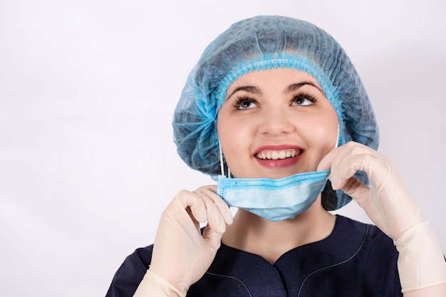 Nurse in protective mask smiles