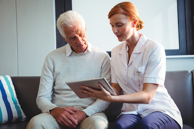 Nurse and senior man using a digital tablet