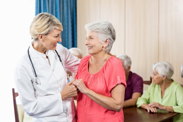 Nurse and senior woman hugging