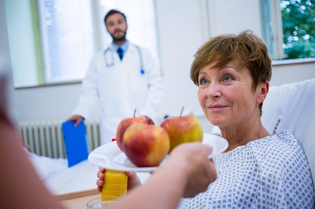 Nurse serving a breakfast to patient