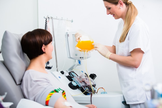 Nurse showing patient donating own blood her blood plasm