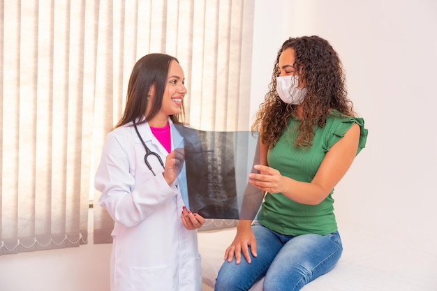 Nurse showing patient her spine x-ray exam.