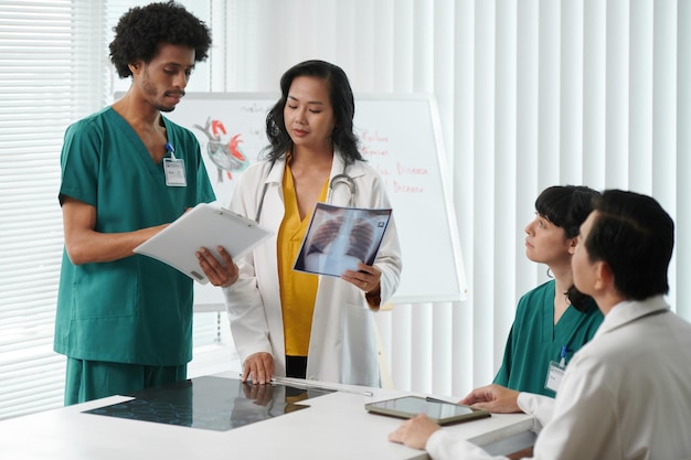 Nurse showing pulmonologist results of medical tests