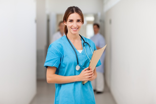 Nurse smiling while holding a file