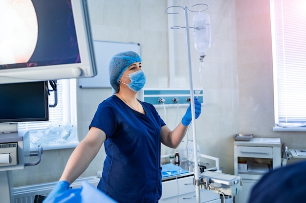 Nurse surgeon at work in operating room.