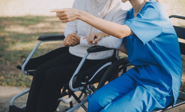 Photo a nurse take care a senior male on wheelchair in his garden at home