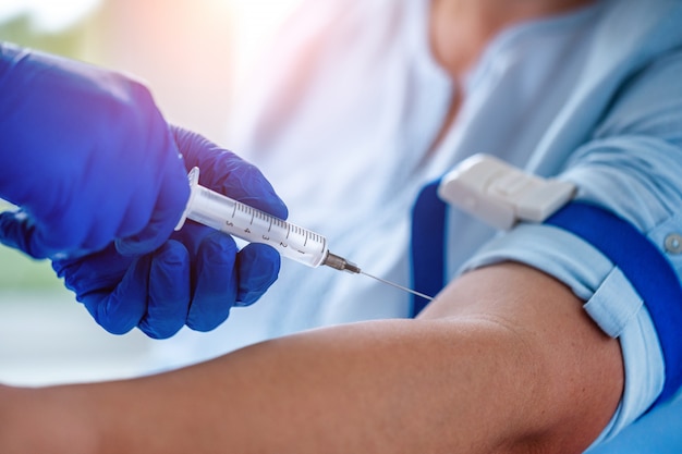 Nurse takes blood from a vein for laboratory test