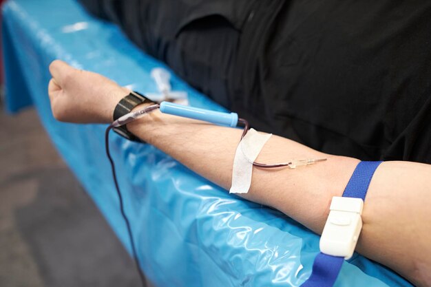 a nurse takes a blood sample. A Doctor Injecting Patient With Syringe To Collect Blood Sample