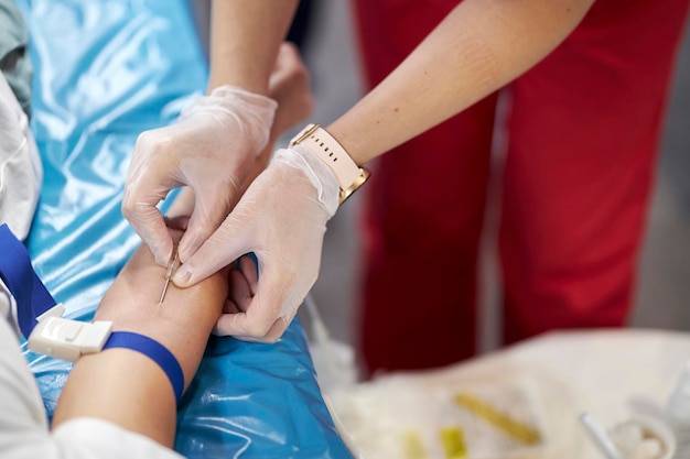 a nurse takes a blood sample. Hand of a doctor in gloves taking a blood sample from a patient