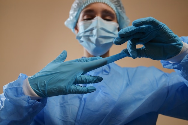 The nurse takes off the medical gloves pandemic 2019 nkov stop\
coronavirus mers