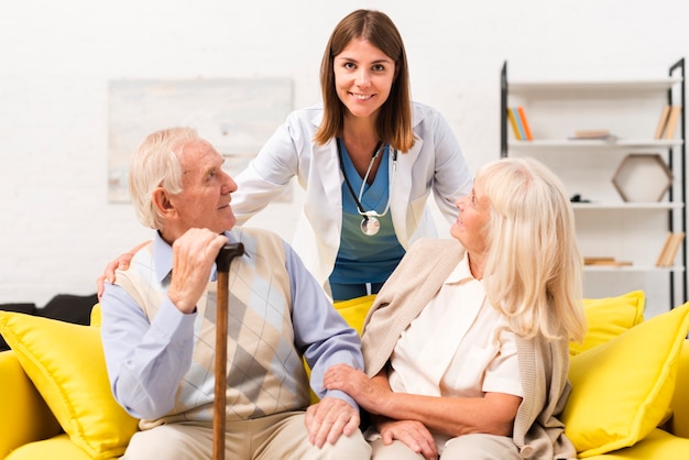 nurse taking care of old man and woman