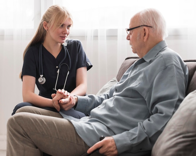 Nurse taking care of old man