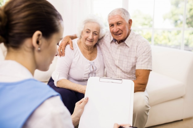 Nurse taking care of sick elderly patients at home