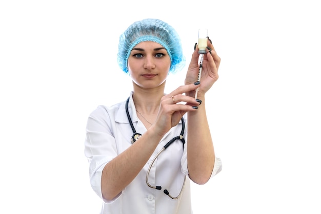 Nurse taking medication from ampoule with syringe