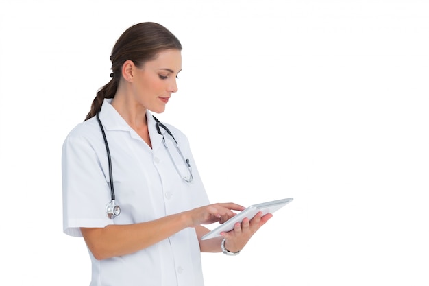 Nurse using her tablet and smiling 