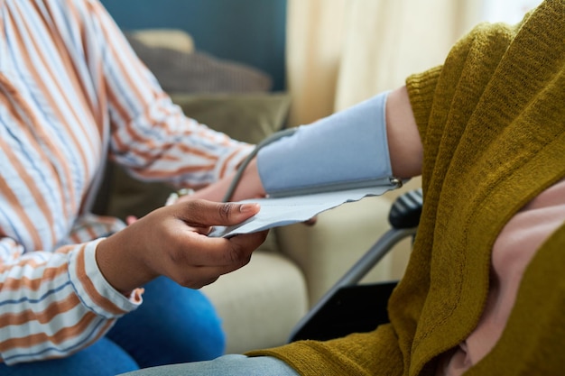 Nurse visiting senior female patient at home