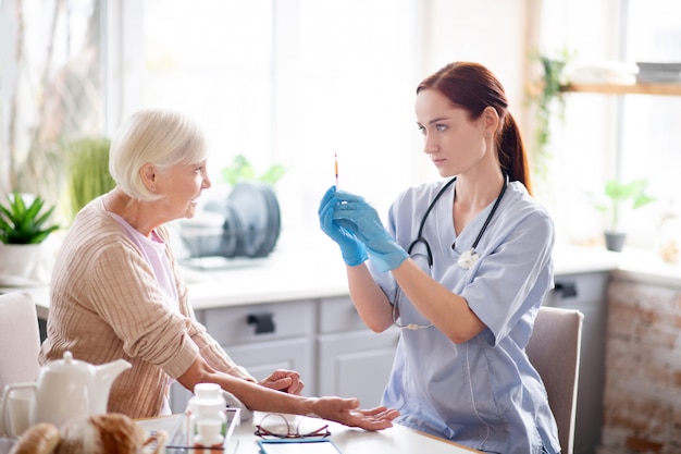 Nurse wearing gloves ready for making injection