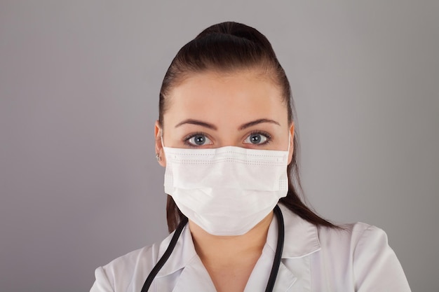 Nurse with gauze and with ponytail is against grey background