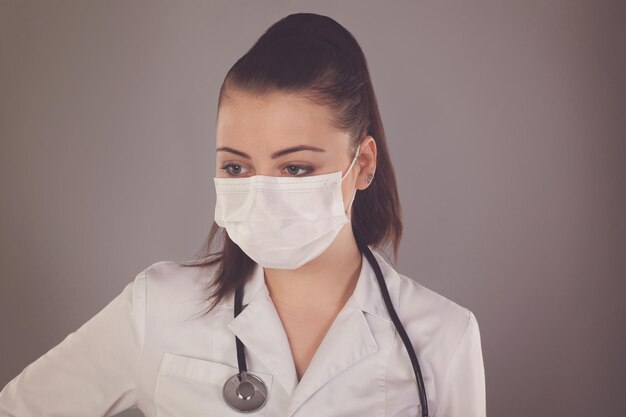 Nurse with gauze and with ponytail is against grey background