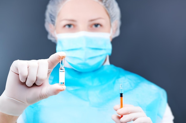 Nurse with syringe and vaccine in hand