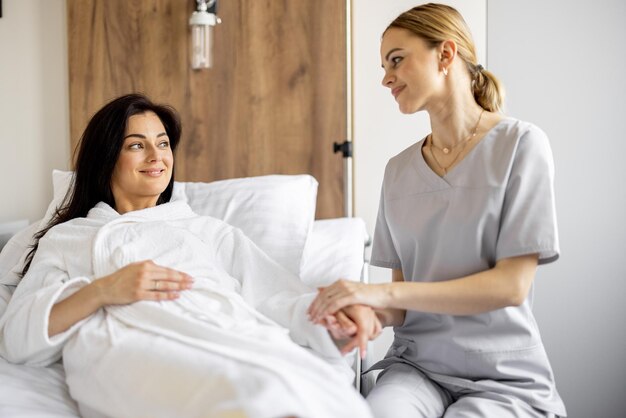 Nurse with a woman in a ward