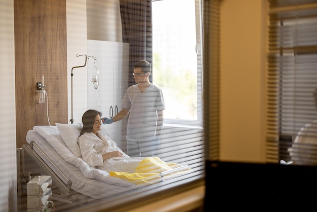 Nurse with a woman in a ward