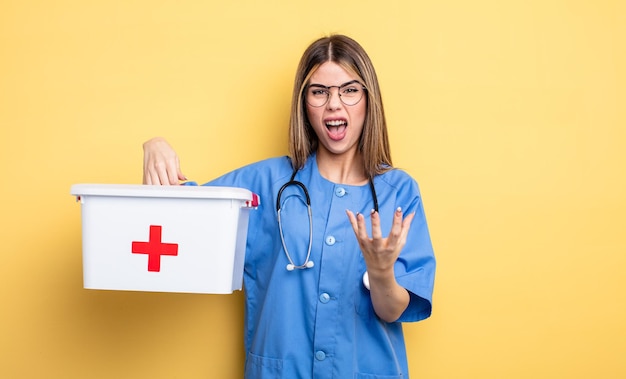 Nurse woman looking angry annoyed and frustrated first aid kit concept