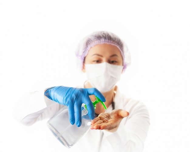 Photo nurse woman in medical protective mask and gloves showing sanitizer or antibacterial soap. prevention and stop  infection concept.