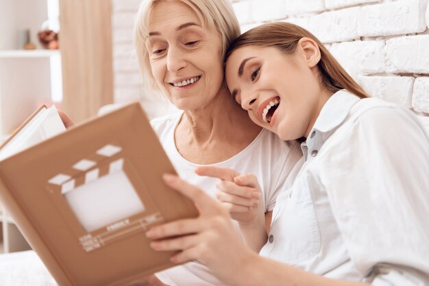 Nursing elderly woman with photo album