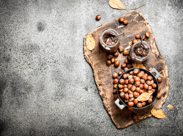Nut butter from hazelnuts and chocolate on rustic background