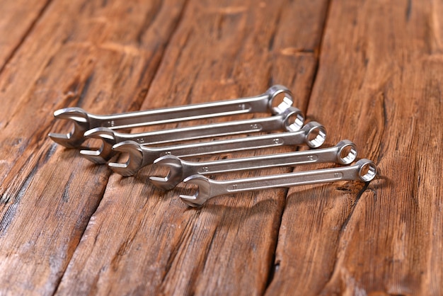 Nut metal wrench on wooden table