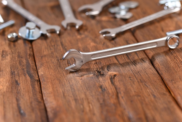 Nut metal wrench on wooden table