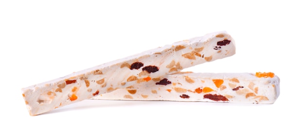 Nut nougat with dried fruit, sweet candy isolated on white space