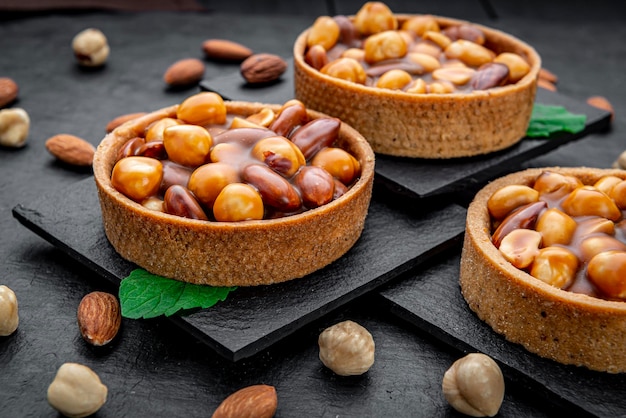 Nut tartlet with hazelnuts almonds and caramel