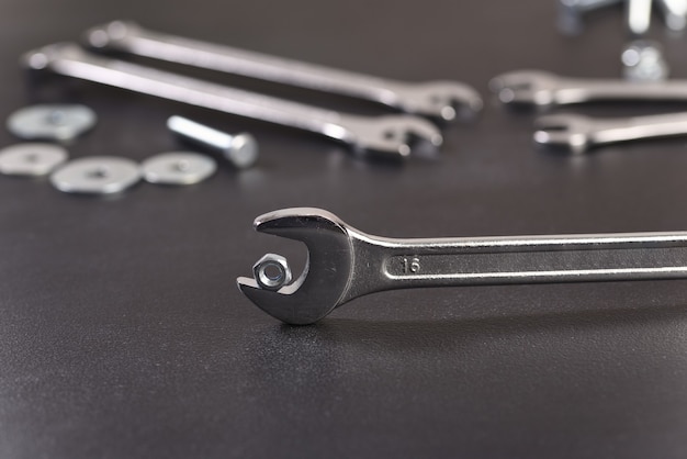 Nut and wrenches on old wooden table