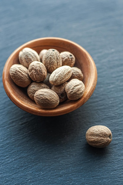 nutmeg fragrant spice spicy seasoning east on a black background close up