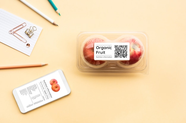 Nutrition information of organic fruit with apple in packaging and qr code, flat lay