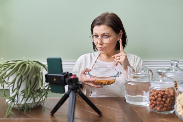 Nutritionist talks about benefits of soaking nuts in water recording video blog vlog