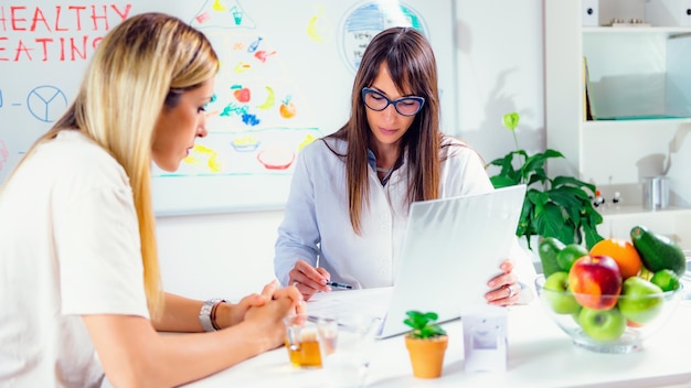 Nutritionist with female patient